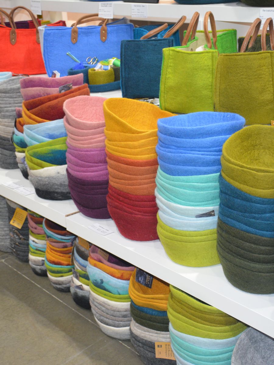 Stacks of brightly coloured felt baskets on a show-floor display