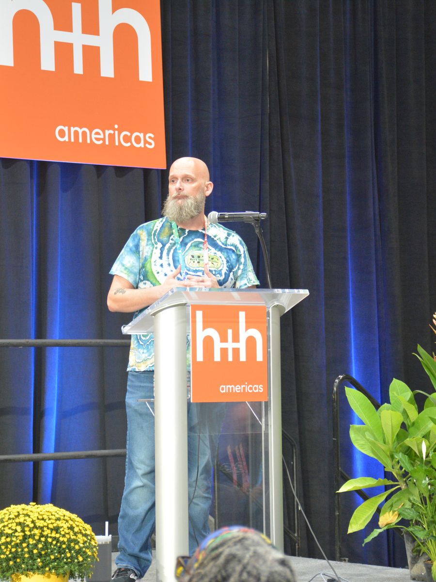 Speaker at the h+h americas Main Stage lectern