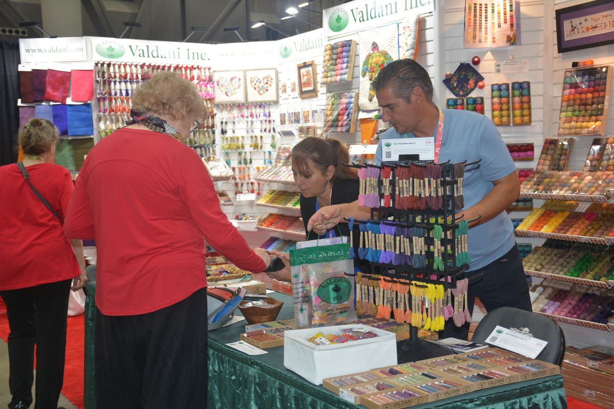 Buyers placing orders at a busy exhibitor booth