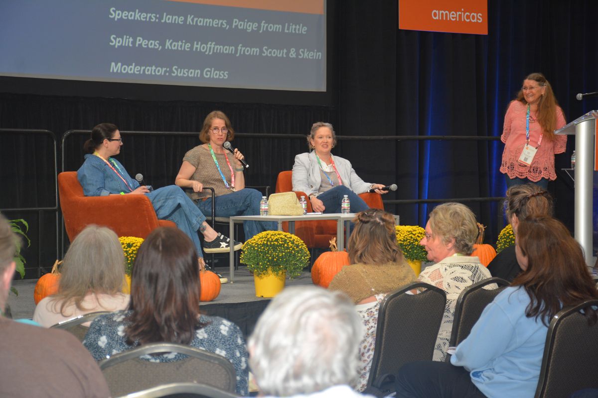 Conference panel on stage in front of a full audience
