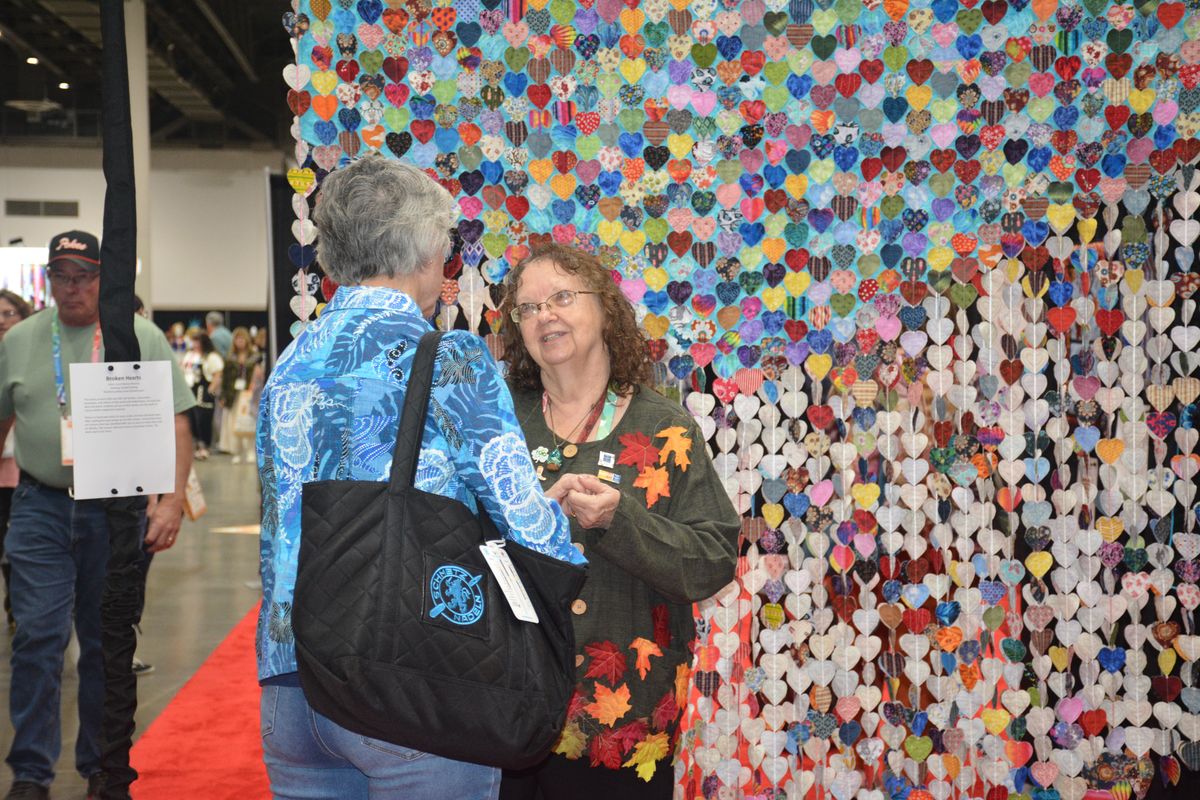 Attendees in front of the community quilt-block wall