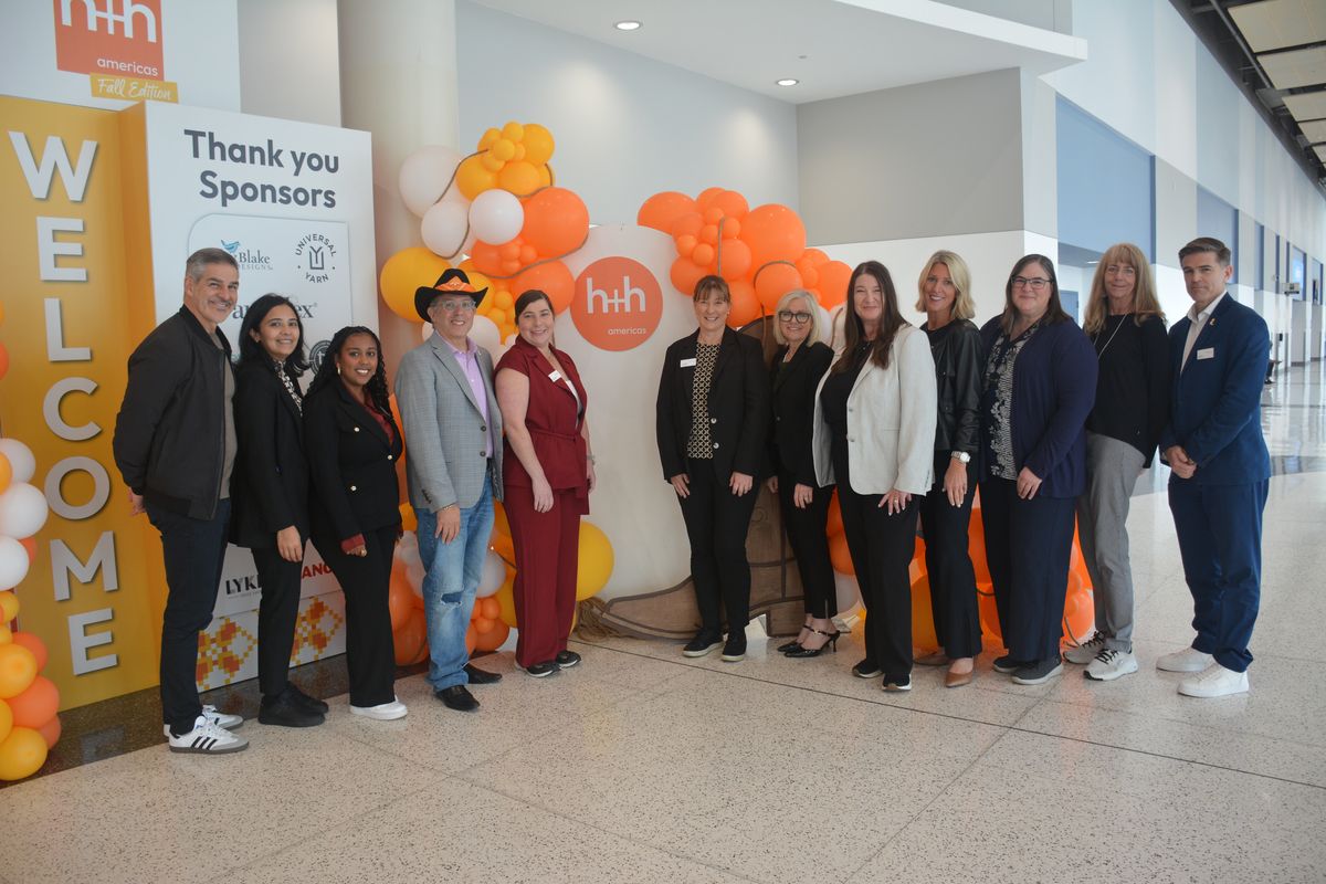 The h+h americas team at the welcome wall on opening day