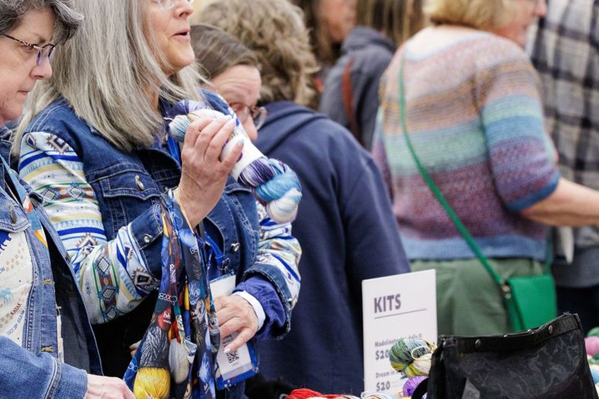 Buyers picking out yarn kits at a Sample It table