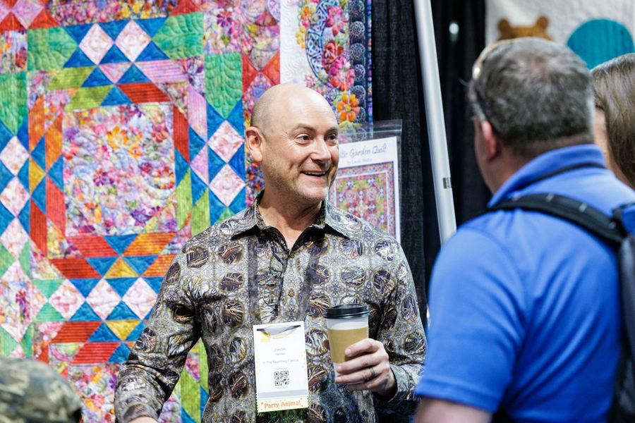 Colorful quilts on display at an exhibitor booth