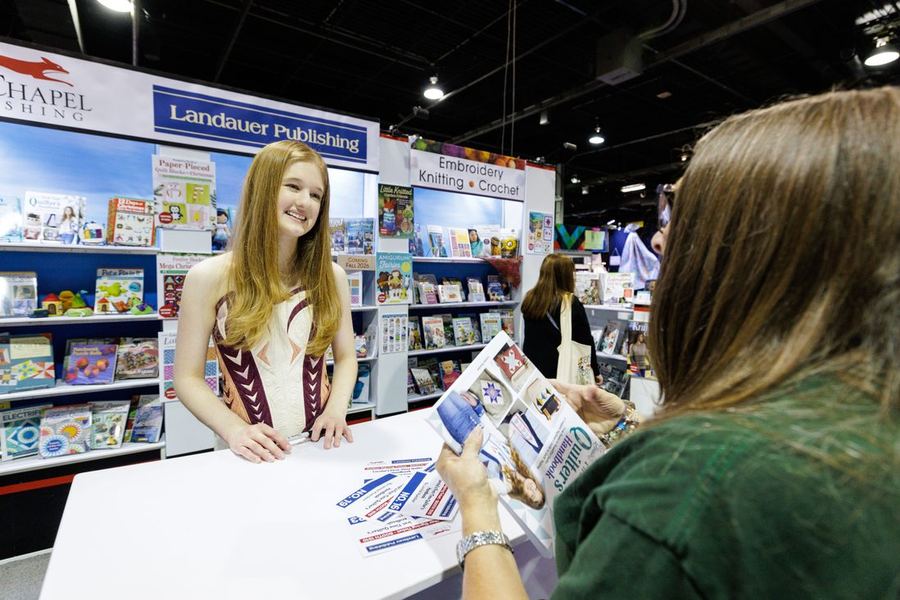 A craft-publishing booth with books and magazines